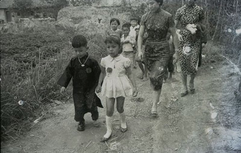 1960年代臺灣婚禮照片：新郎與新娘身著西式禮服，身旁由年幼男女兒童擔任的花童（花仔與花女）隨行，畫面展現當時漢人傳統習俗與西式婚禮文化融合的歷史樣貌。